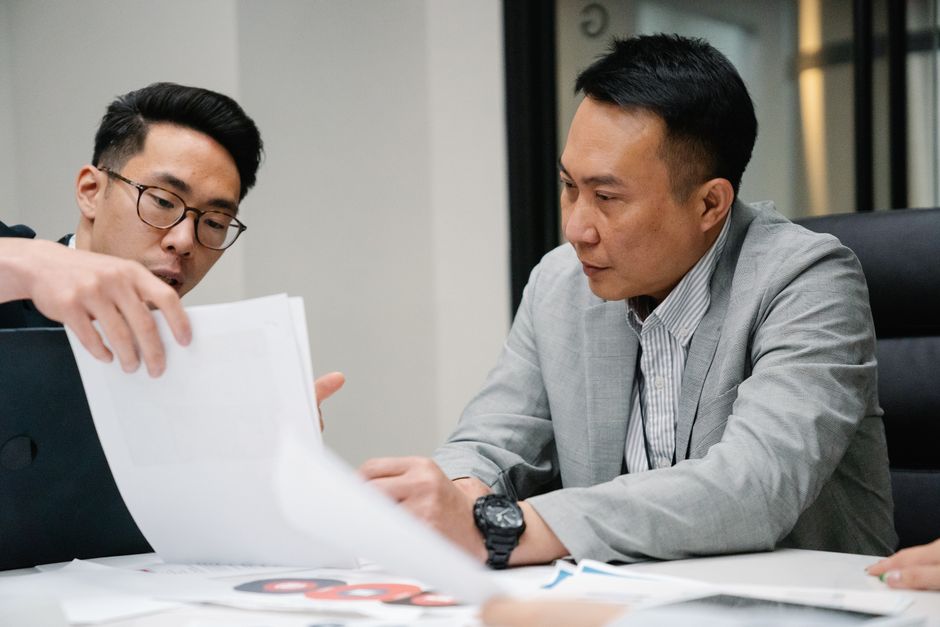 Two people reviewing documents at a table